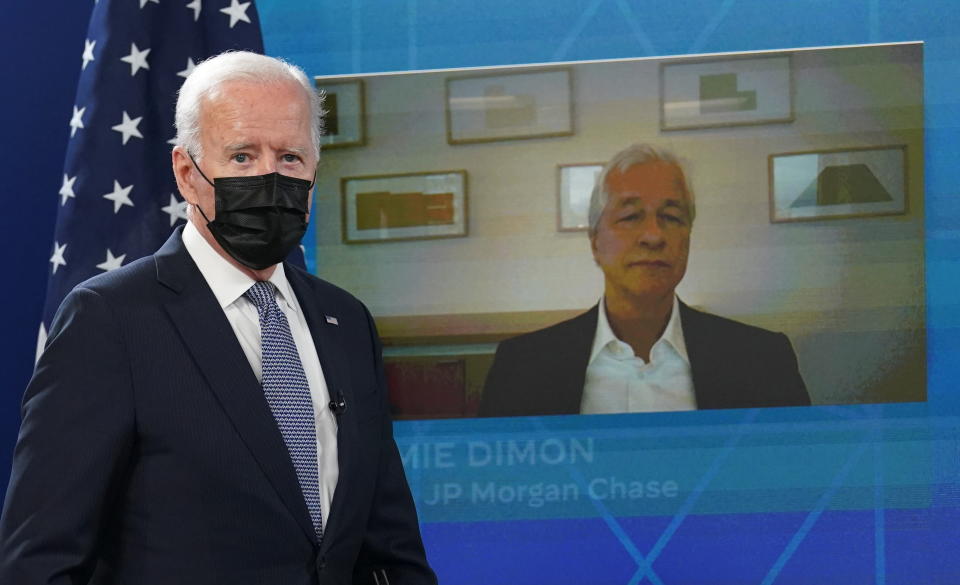 JP Morgan Chase CEO Jamie Dimon is seen on the video screen as U.S. President Joe Biden arrives for a hybrid virtual meeting with business leaders and CEOs about the debt limit at the White House in Washington, U.S., October 6, 2021. REUTERS/Kevin Lamarque     